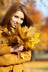 Beautiful elegant woman in a autumn park