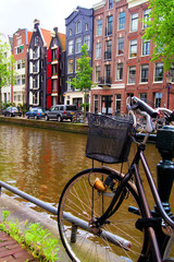 Naklejka premium Bicycle along the canals of Amsterdam, The Netherlands