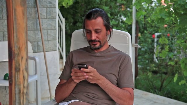 brunette man text massage cellphone
