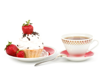 Dessert - sweet cake with strawberry and teacup on a plate