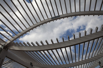Naklejka premium White Wooden Arbor/Pergola with blue sky in distance.