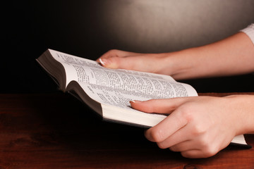 Hands holding russian holy bible