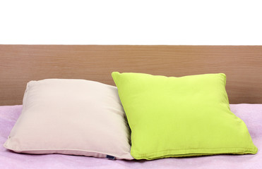 bright pillows on bed on white background