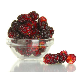Transparent bowl with ripe mulberries isolated on white
