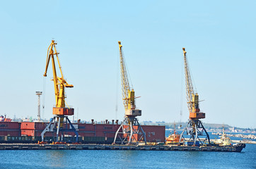 Fototapeta premium Tugboat under crane bridge in port of Odessa, Ukraine