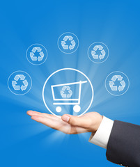 shopping cart and recycle icon on business hand