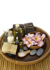 Spa accessories in wooden bowl on mat