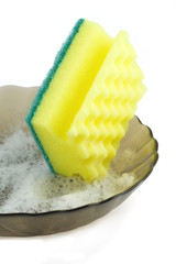 Washing the dishes with a sponge.