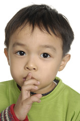 thinking boy holding finger near his mouth