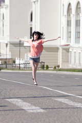 Brunette in shorts running along the carriageway