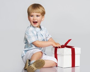 Happy baby boy with a gift box