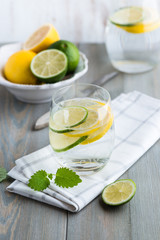 Glass of cold water with lime and lemon