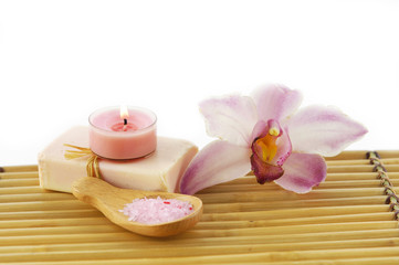 Fototapeta na wymiar Spa resort-orchid, candle on soap, salt in spoon