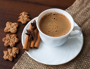 Coffee cup with cinnamon and cookies