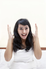 Cheerful woman in bed