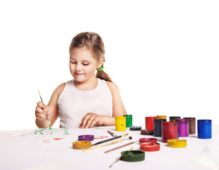 small beautiful girl paints on paper over white