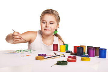 small beautiful girl paints on paper over white