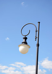 Fototapeta na wymiar Park round light lamp on pole on background of sky