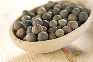 Allspice pepper (Jamaica pepper) in the wooden spoon