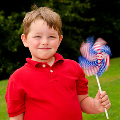 Child playing with American flag pinwheel on Independence Day