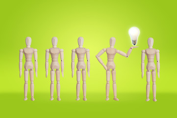 Wooden model in the row of wooden model with bulb idea concept