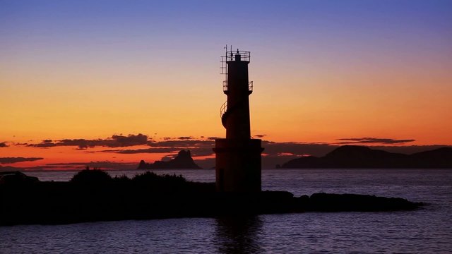 Ibiza island sunset of Es Vedra and La  Savina lighthouse