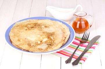 Stack of tasty pancakes on wooden background