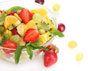 glass bowl with fresh fruits salad and berries isolated on