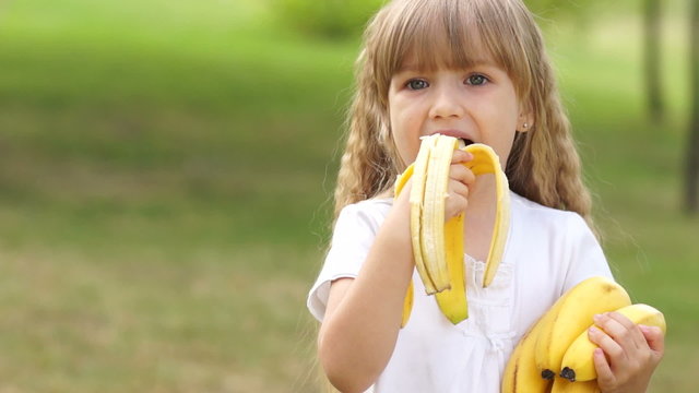Child eating bananas outdoor