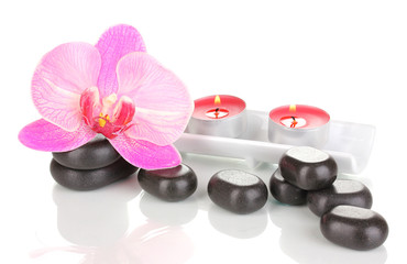 Spa stones with orchid flower and candles isolated on white