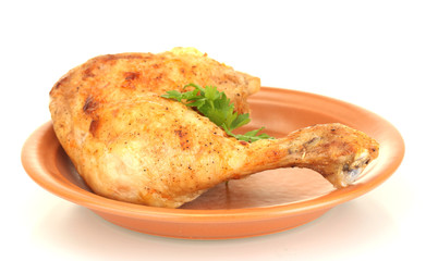 roasted chicken leg with parsley in the plate isolated on white