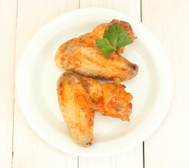 roasted chicken wings with parsley in the plate