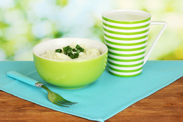 Mashed potato in the bowl and cup with milk