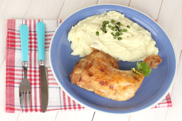 roasted chicken leg with mashed potato in the plate