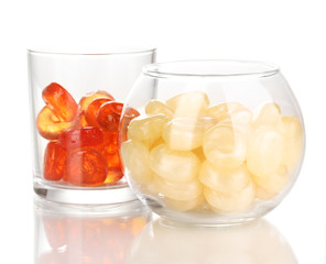 Color candies in glasses isolated on white