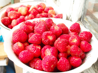 Red strawberry in  tableware