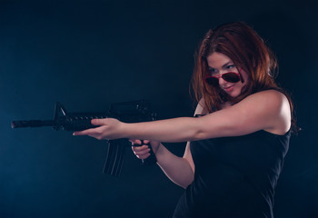 Woman looking over her glasses while aiming a gun