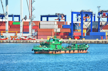 Container stack and ship under crane bridge