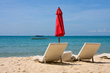 Sun loungers with an umbrella on the beach