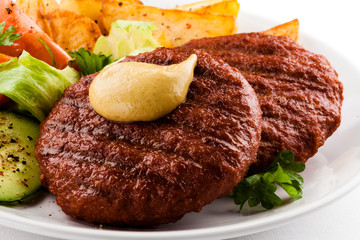 Grilled beefsteak, baked potatoes and vegetables