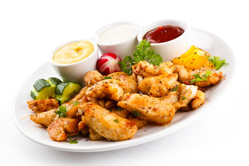 Grilled meat and vegetables on white background