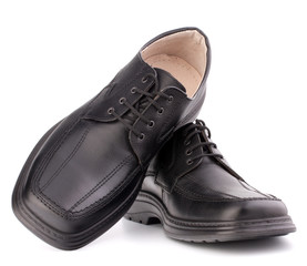 Black glossy man’s shoes with shoelaces