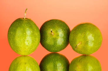 green passion fruit on pink background close-up