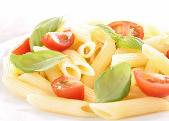 plate of pasta with tomato and basil