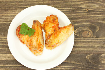 roasted chicken wings with parsley in the plate