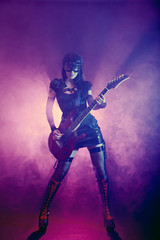 Obraz na płótnie Canvas Goth girl in goggles plays guitar