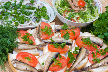 Sandwiches with sprats on a plate