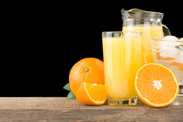 fresh orange fruits juice and slices isolated on black