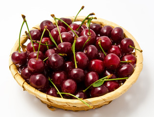 Basket with ripe wet cherry isolated