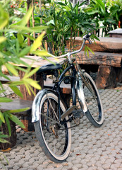 Fototapeta na wymiar a black bicycle leaning against wooden table